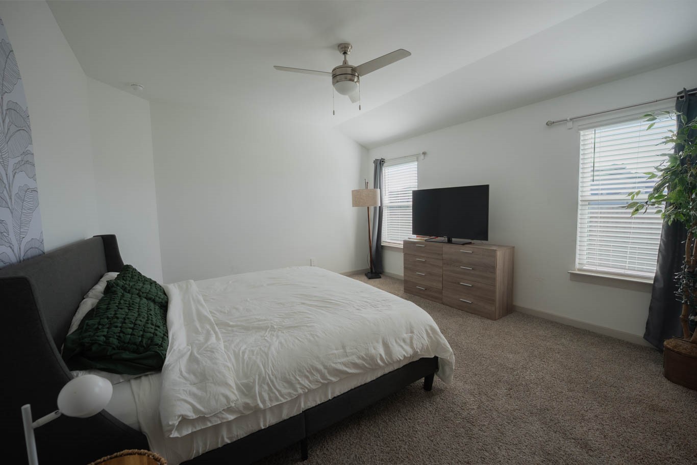 12732 Basinghall Lane Houston, TX 77047 - Photo 12 of 20 a bedroom with a bed and a flat screen tv
