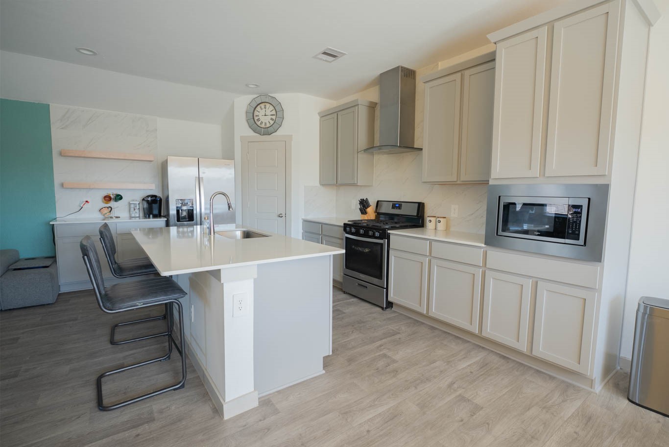 12732 Basinghall Lane Houston, TX 77047 - Photo 6 of 20 a kitchen with stainless steel appliances a sink a stove a refrigerator cabinets and chairs