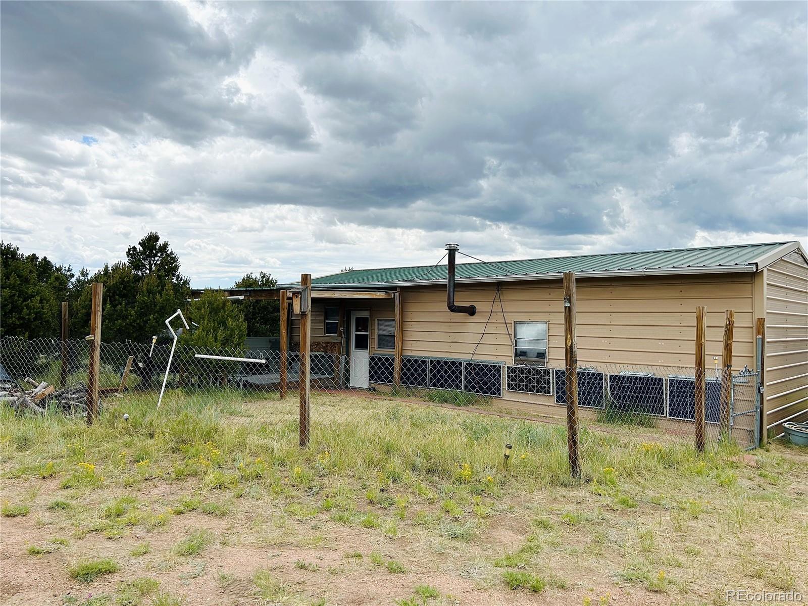 4535 Sarnoff Road Fort Garland, CO 81133 - Photo 3 of 44 a backyard of a house with table and chairs