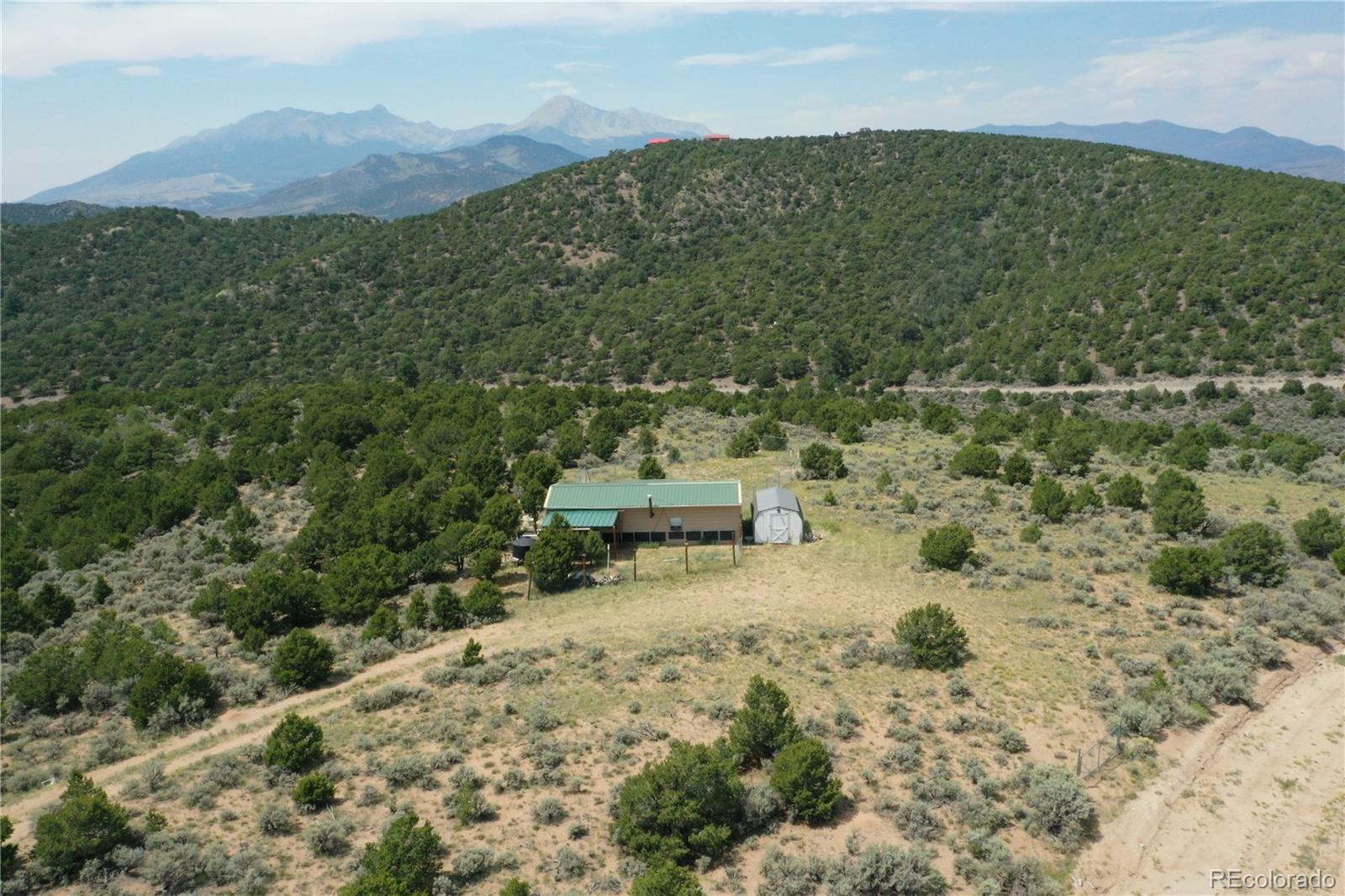 4535 Sarnoff Road Fort Garland, CO 81133 - Photo 37 of 44 a view of a lush green hillside and a houses
