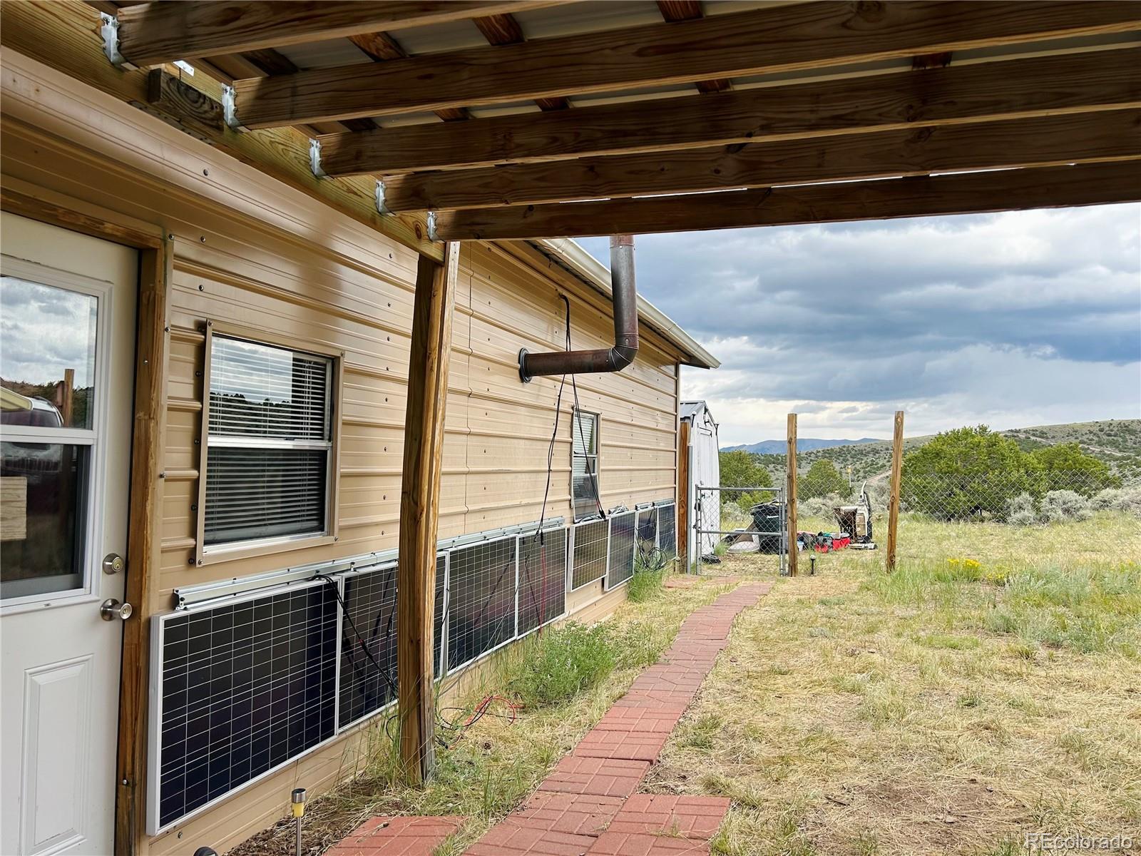 4535 Sarnoff Road Fort Garland, CO 81133 - Photo 4 of 44 a view of a porch with a table and chairs