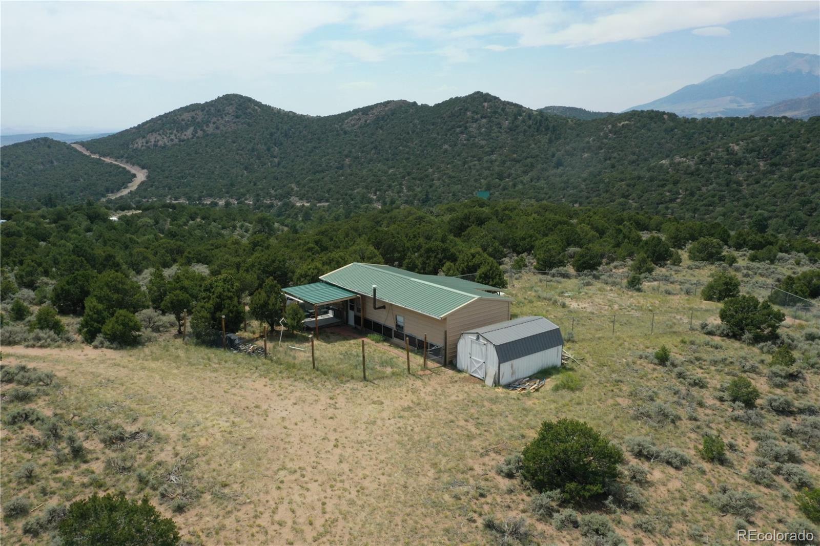4535 Sarnoff Road Fort Garland, CO 81133 - Photo 43 of 44 a view of a house with a yard