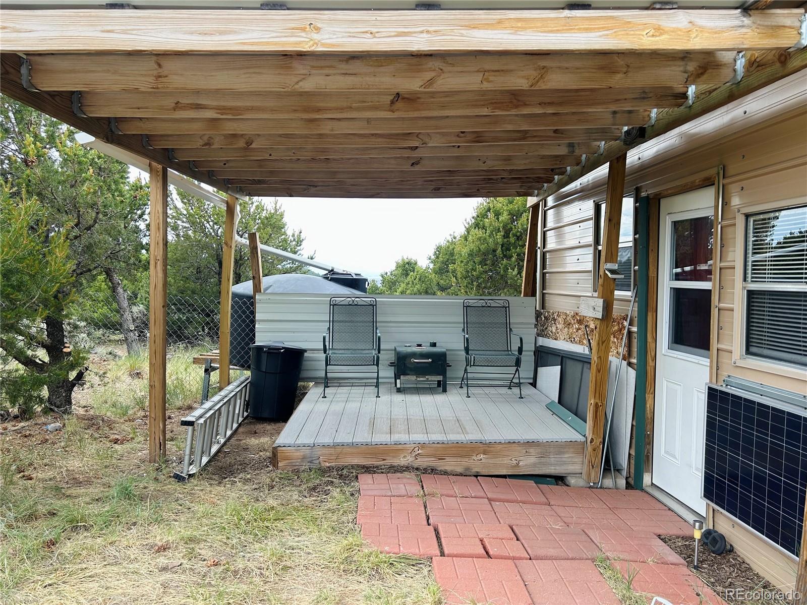 4535 Sarnoff Road Fort Garland, CO 81133 - Photo 5 of 44 a view of backyard with a deck and furniture
