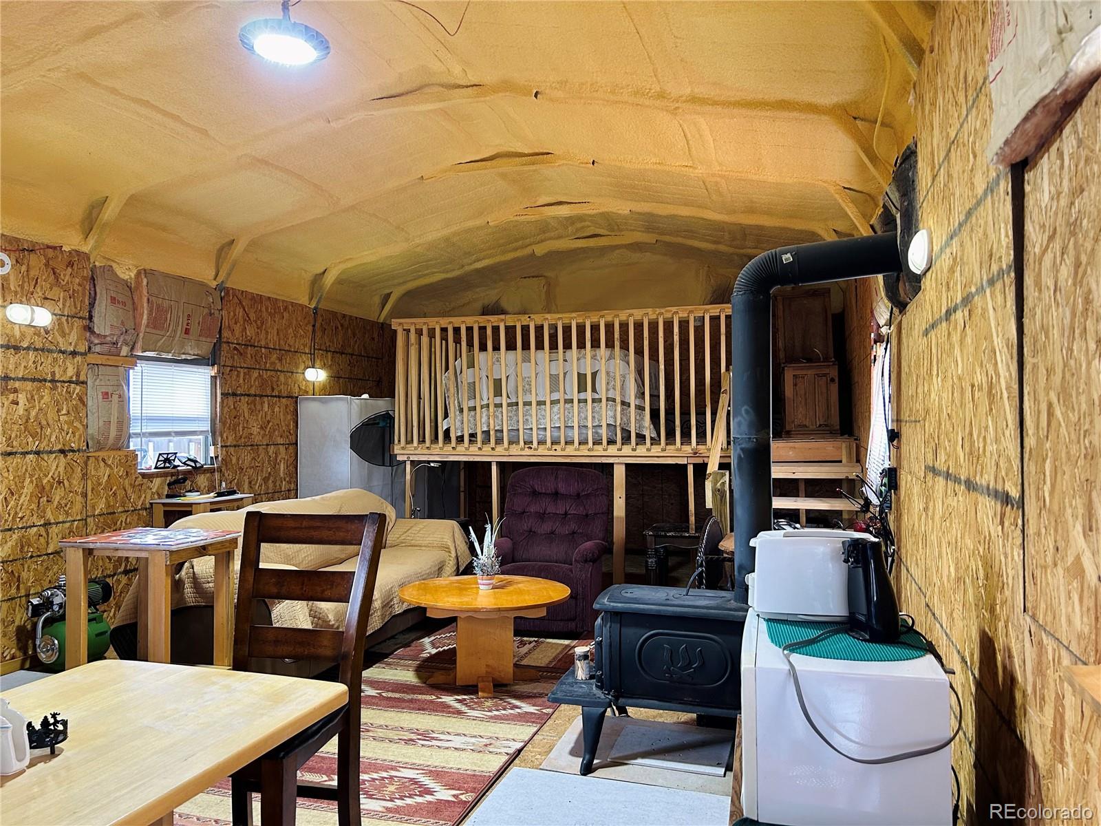 4535 Sarnoff Road Fort Garland, CO 81133 - Photo 8 of 44 a front view of a house with outdoor seating