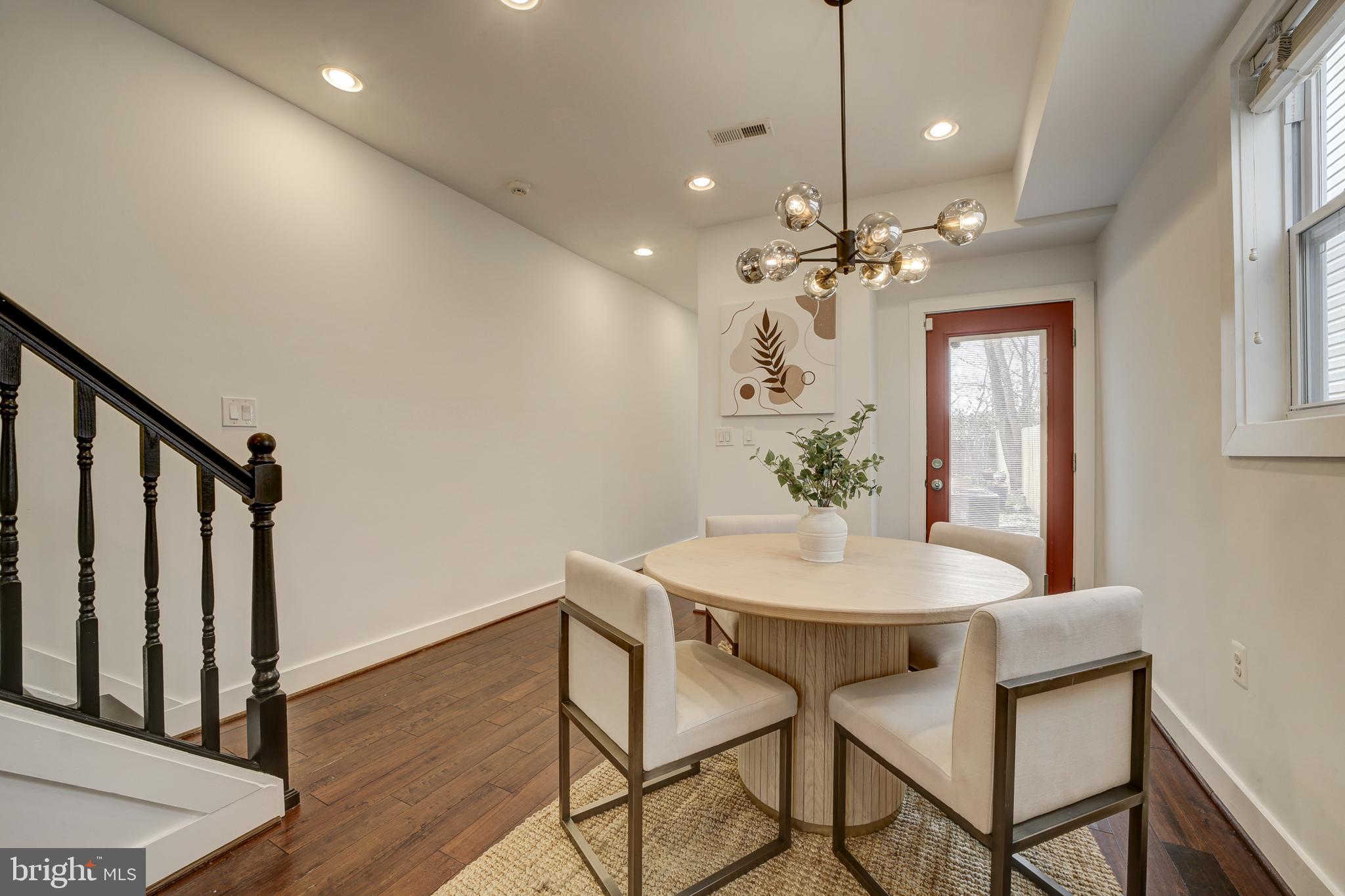 2012 2nd Street Northwest Washington, DC 20001 - Photo 11 of 28 a dining room with furniture a chandelier and wooden floor