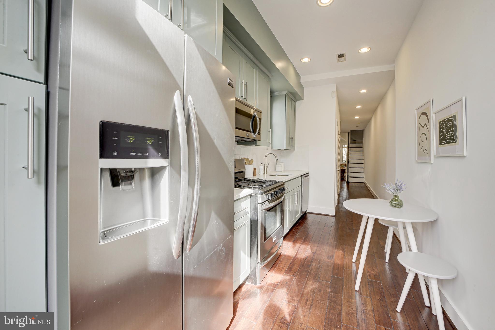 2012 2nd Street Northwest Washington, DC 20001 - Photo 15 of 28 a kitchen with stainless steel appliances kitchen island a refrigerator and a stove top oven