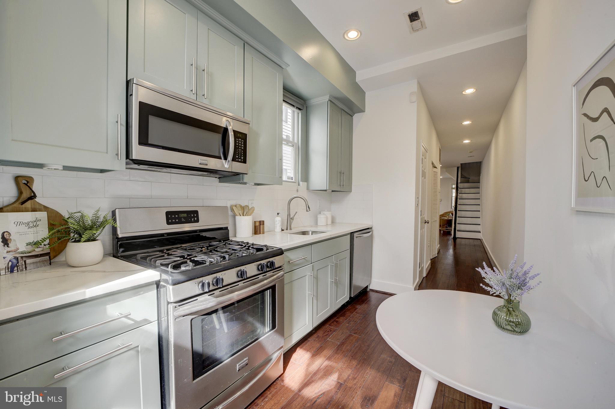 2012 2nd Street Northwest Washington, DC 20001 - Photo 16 of 28 a kitchen with granite countertop a sink a stove and microwave