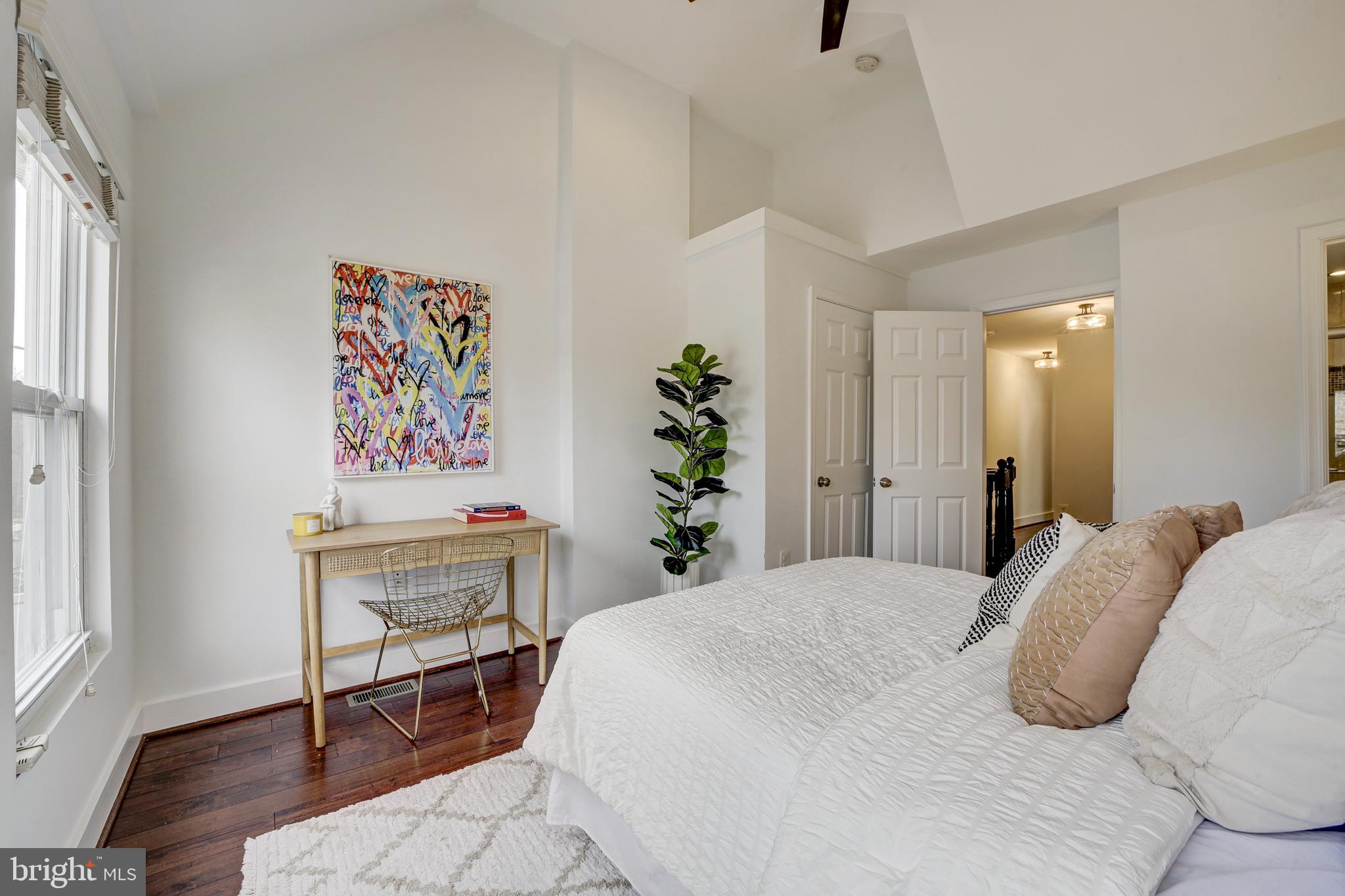 2012 2nd Street Northwest Washington, DC 20001 - Photo 19 of 28 a bedroom with a bed and a painting on the wall