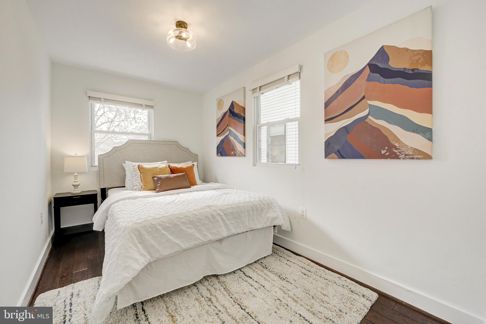 2012 2nd Street Northwest Washington, DC 20001 - Photo 21 of 28 a bedroom with a bed and a painting on the wall