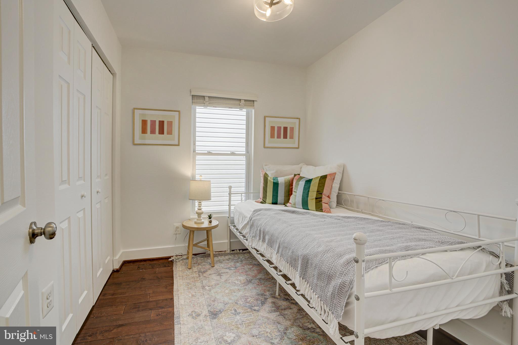 2012 2nd Street Northwest Washington, DC 20001 - Photo 23 of 28 a bedroom with a bed and wooden floor