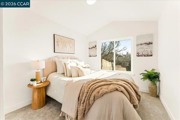 a bedroom with bed and a potted plant