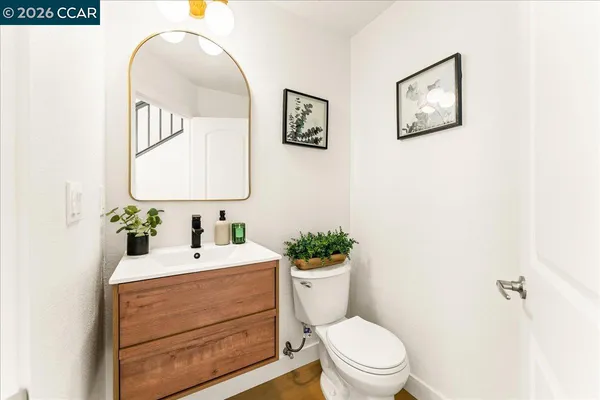 a bathroom with a toilet a sink and mirror