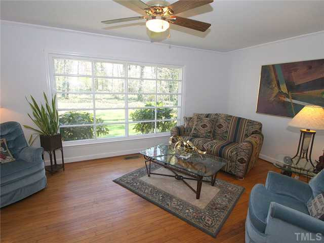 4307 Malvern Road Durham, NC 27707 - Photo 3 of 18 Hardwood floors and a gorgeous view of the big back yard are seen from the living room.