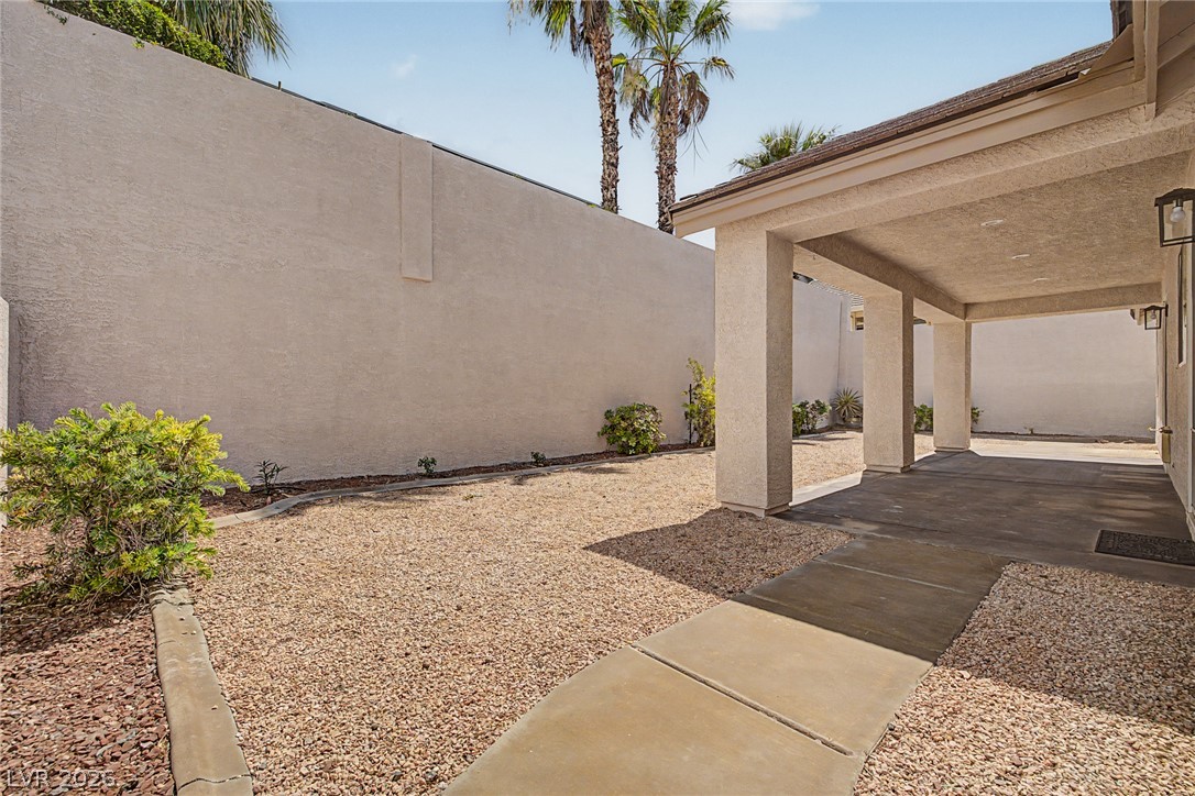 835 Entrada Ridge Avenue Henderson, NV 89012 - Photo 32 of 34 A spacious covered patio provides a shaded outdoor living area with a desert-friendly gravel yard.