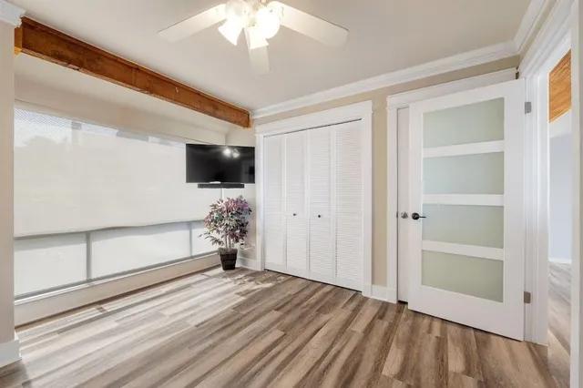 a view of a livingroom with wooden floor and a chandelier