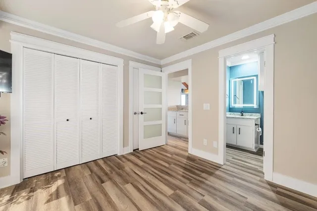 a view of a room with wooden floor and a bathroom