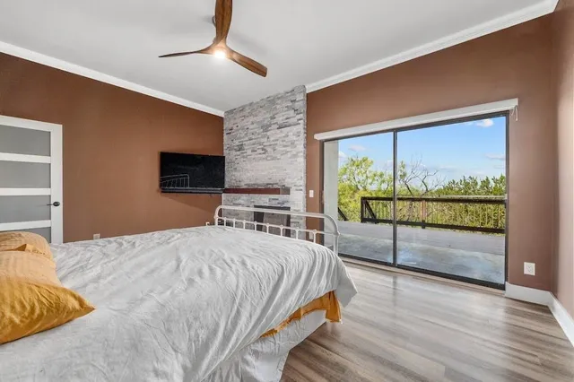 a bedroom with a bed and a flat tv screen on dresser