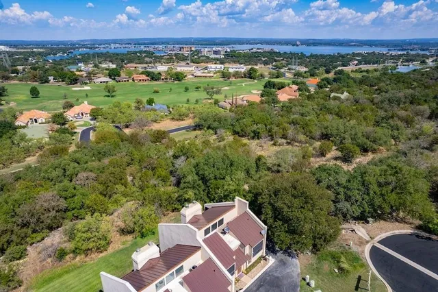 an aerial view of a house with a yard