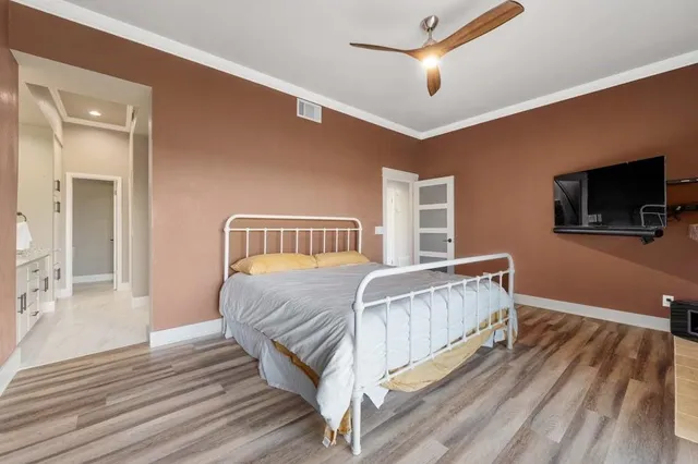 a bedroom with bed and flat screen tv
