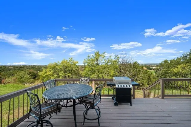 a view of a chairs and table on the deck