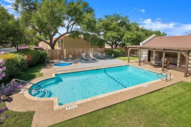 a view of a house with pool and a yard