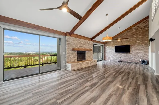a view of a livingroom with wooden floor and furniture