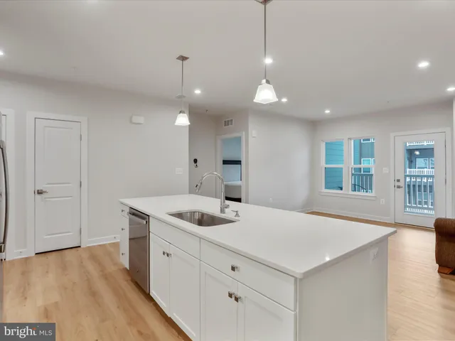 a kitchen with refrigerator a sink and stove