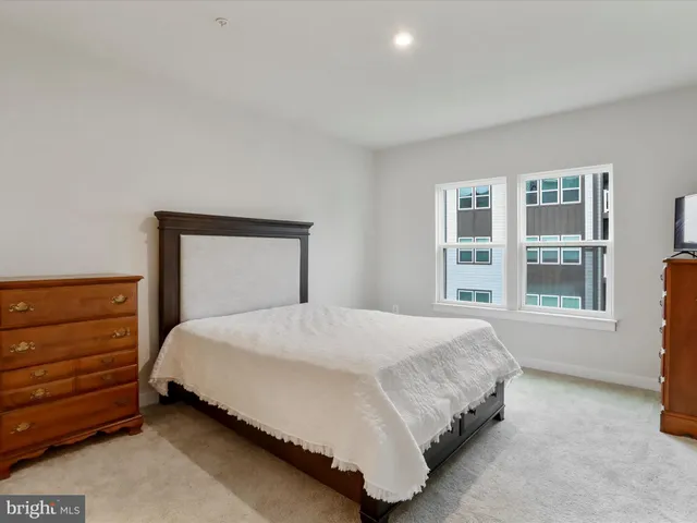 a bedroom with a large bed and a night lamp