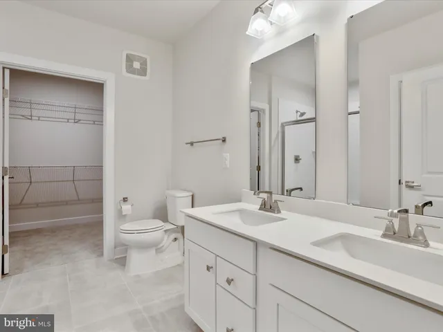 a bathroom with a glass shower door and a bathtub
