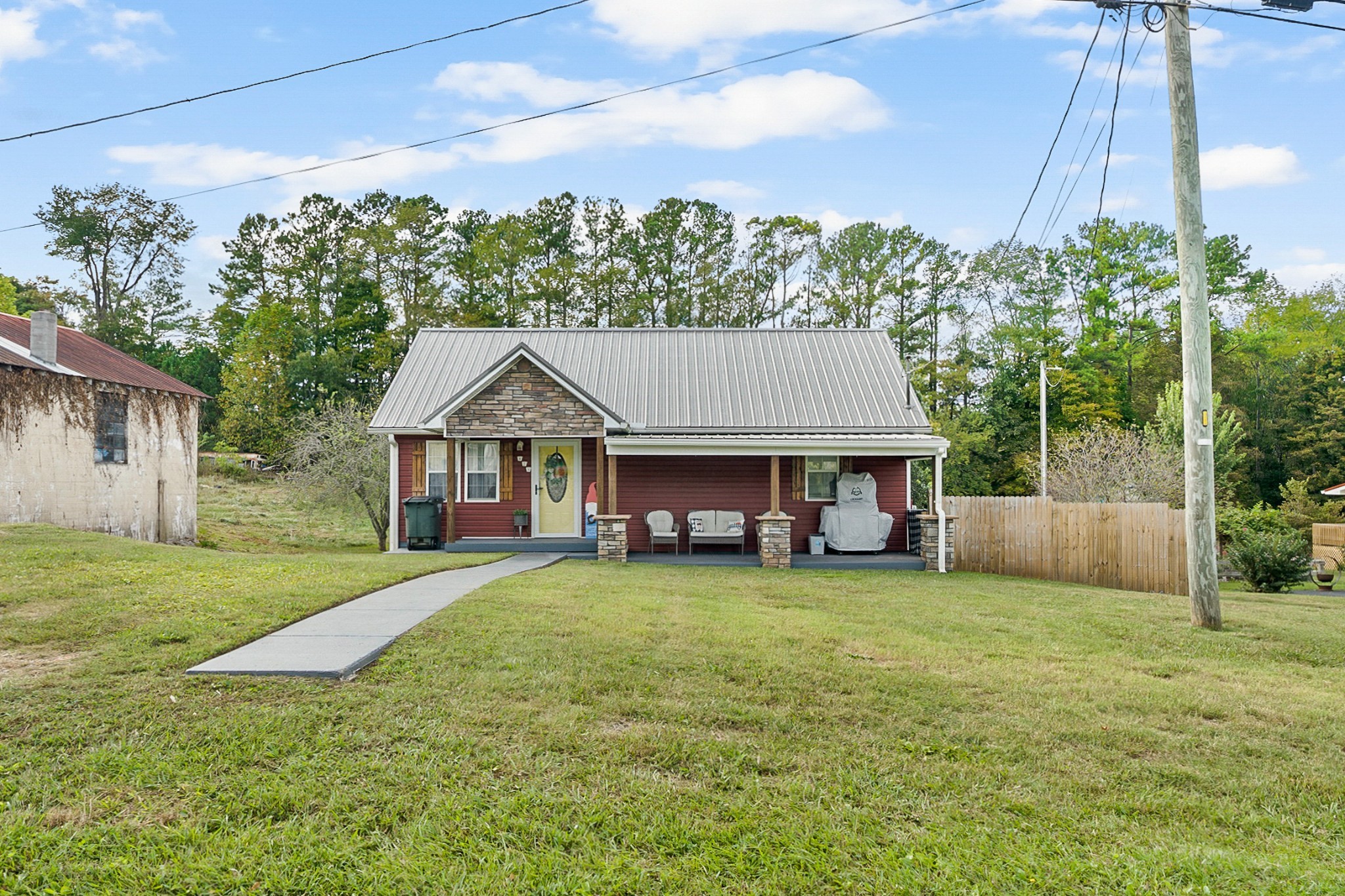 a view of a house with a yard and sitting area