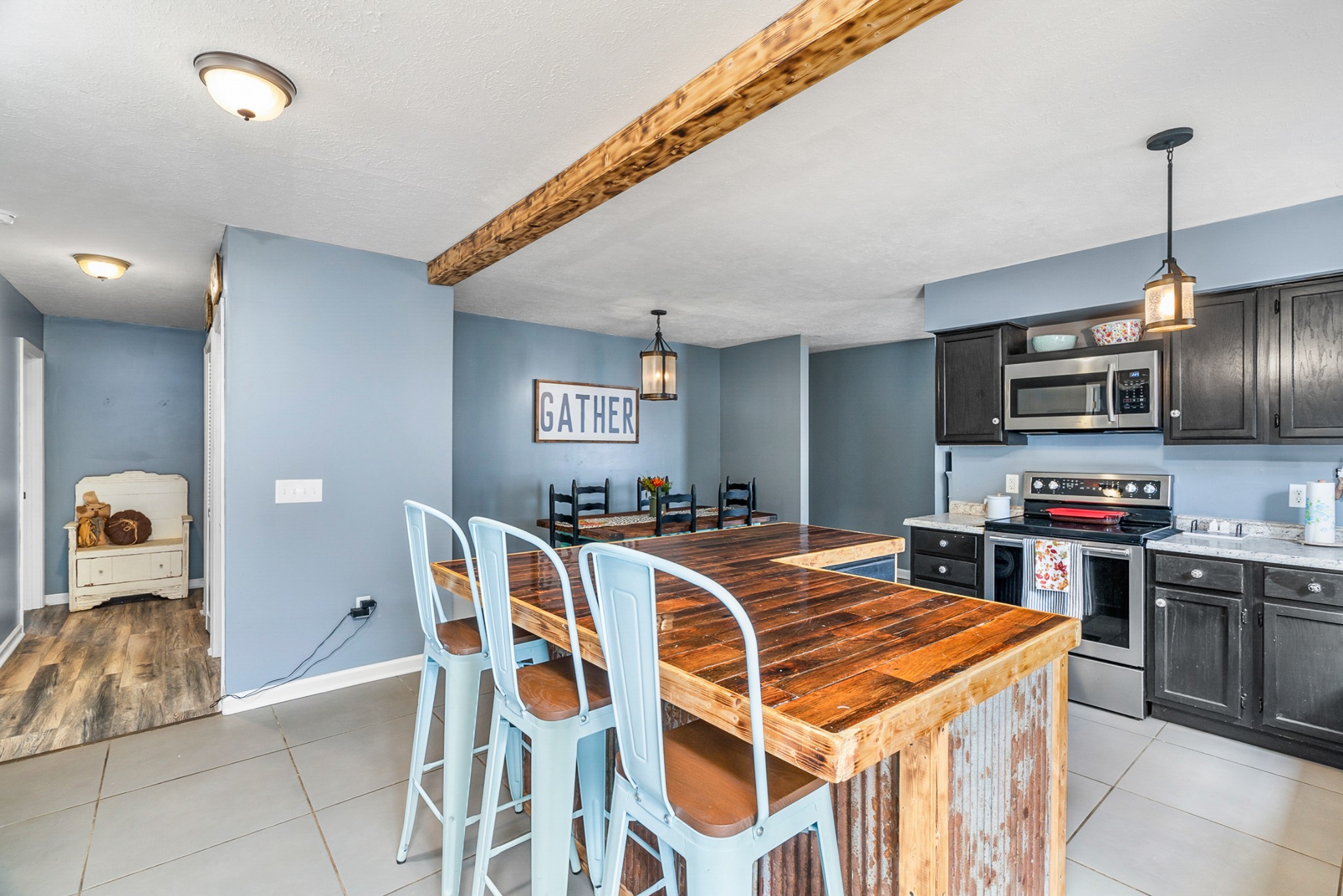 425 South Young Street Sparta, TN 38583 - Photo 11 of 34 a kitchen with stainless steel appliances granite countertop a stove top oven a sink a dining table and chairs with wooden floor