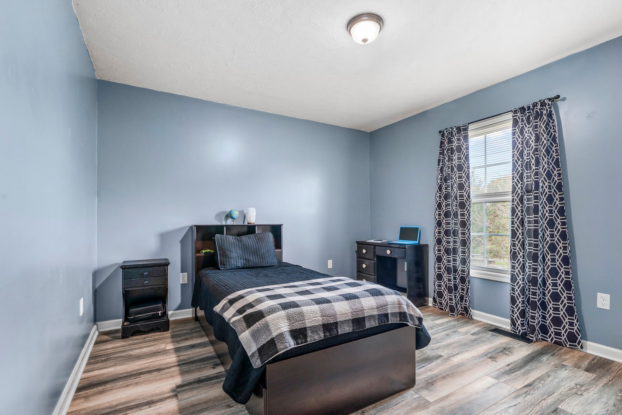 425 South Young Street Sparta, TN 38583 - Photo 15 of 34 a bedroom with a bed and a chair