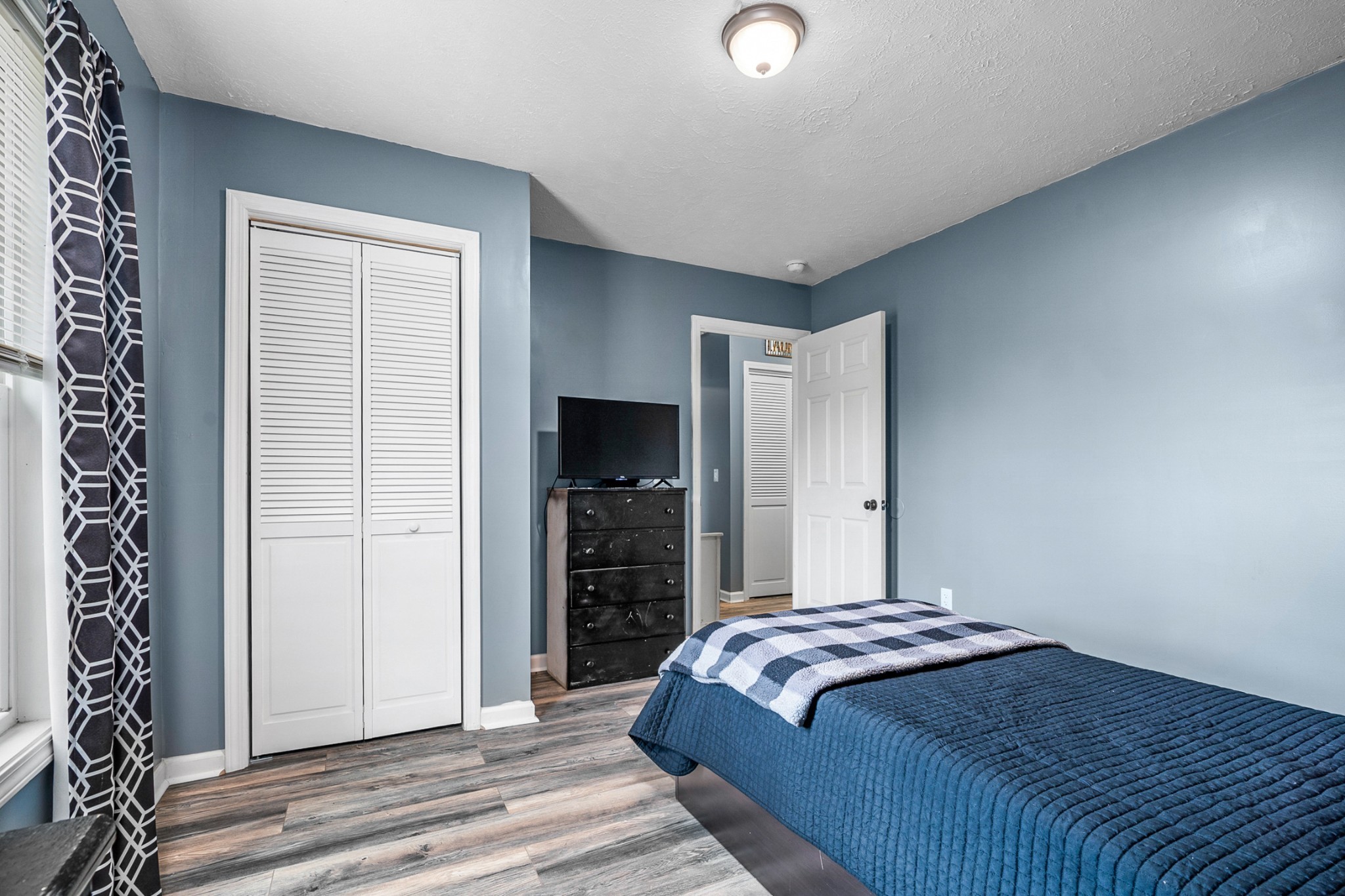 425 South Young Street Sparta, TN 38583 - Photo 16 of 34 a bedroom with a bed and a flat screen tv