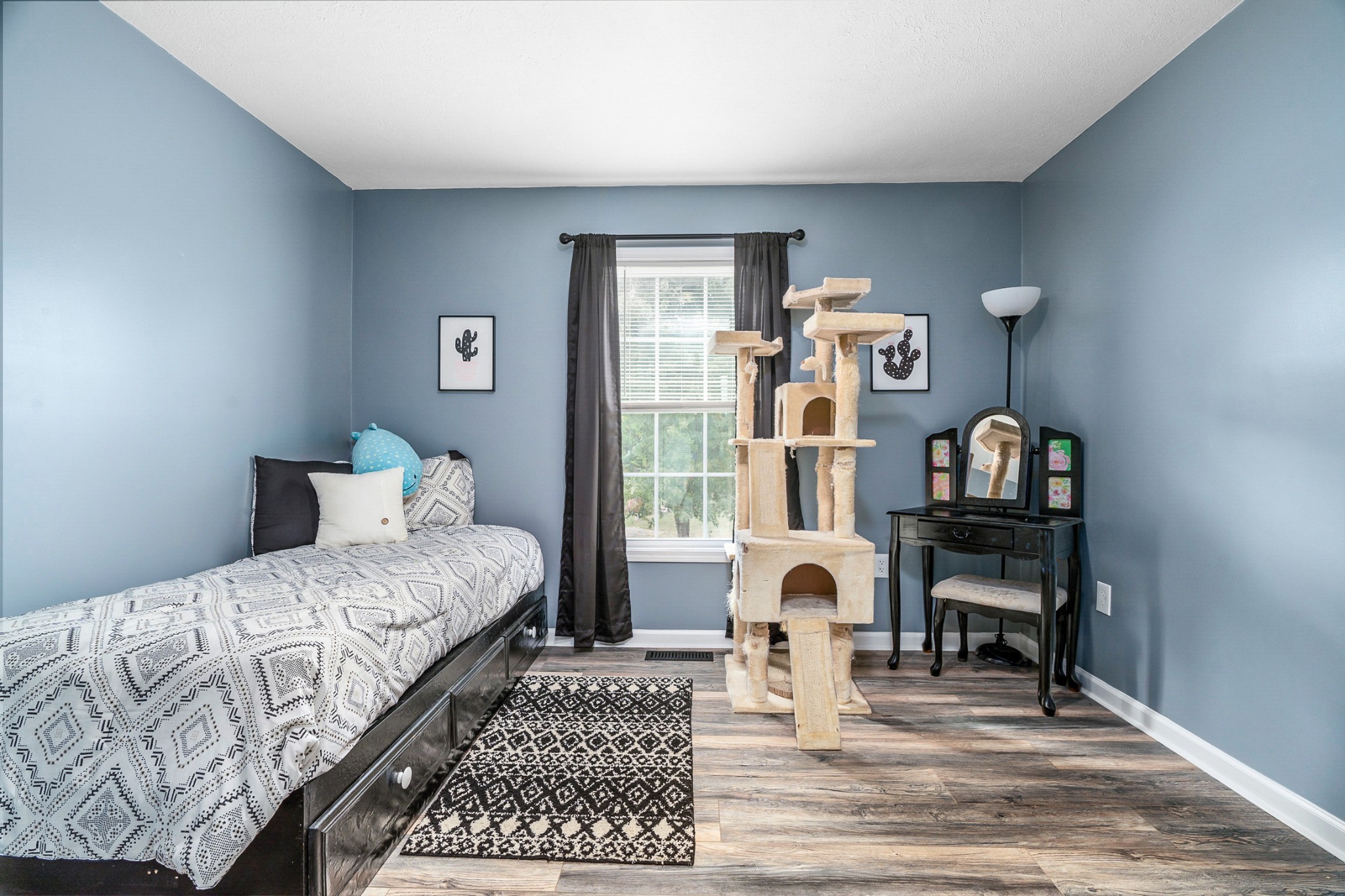 425 South Young Street Sparta, TN 38583 - Photo 17 of 34 a bedroom with a bed and a bookshelf with wooden floor