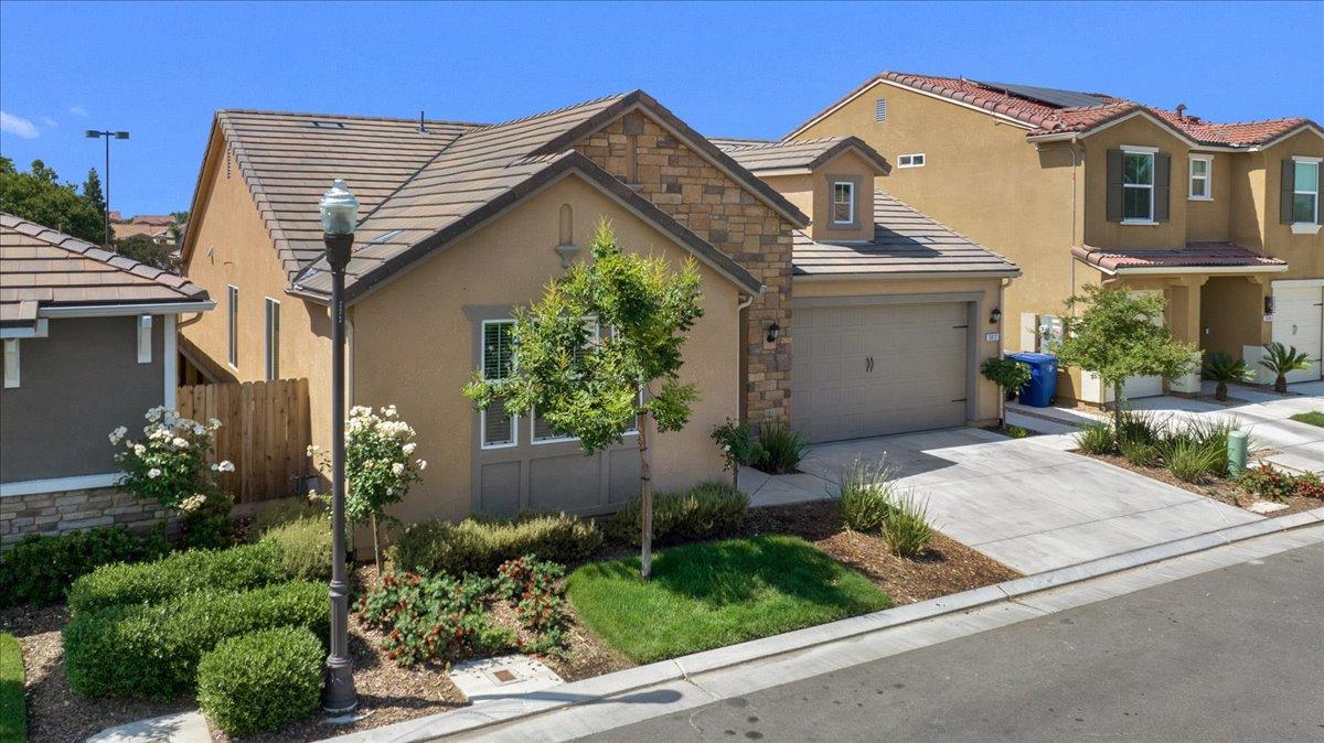 a front view of a house with garden