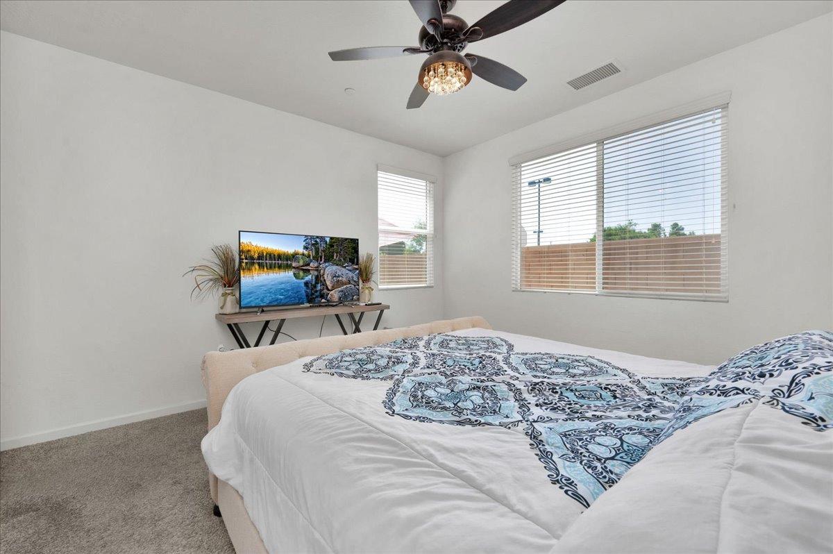 3012 Swift Lane Clovis, CA 93619 - Photo 14 of 40 a bedroom with a bed and wooden floor