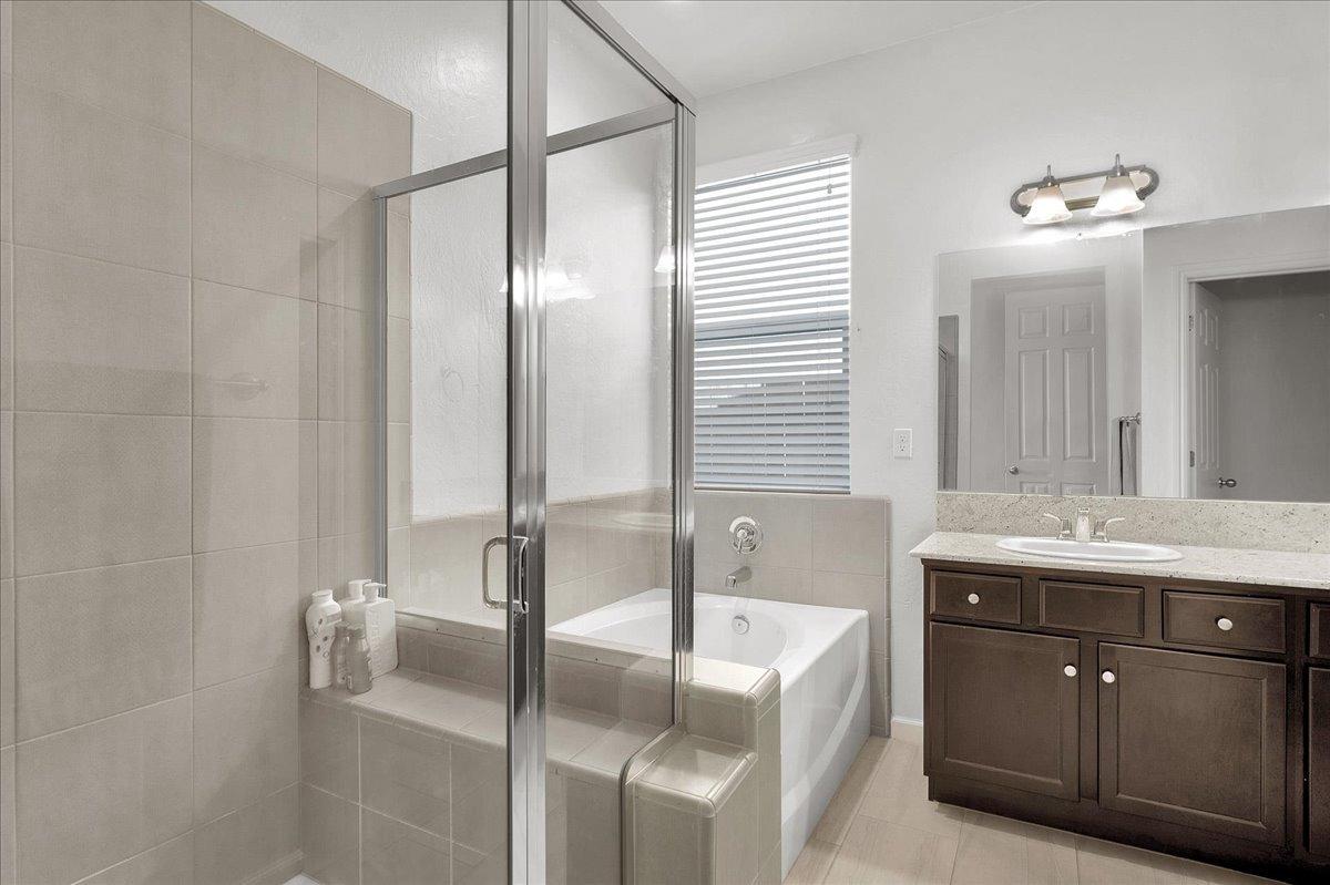 3012 Swift Lane Clovis, CA 93619 - Photo 16 of 40 a spacious bathroom with a granite countertop sink and a mirror