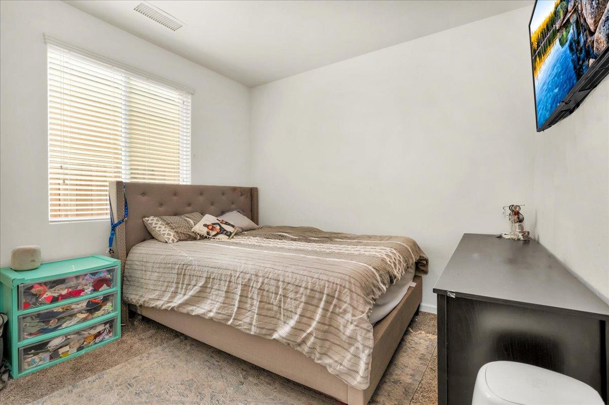 3012 Swift Lane Clovis, CA 93619 - Photo 22 of 40 a bedroom with a bed and a dresser
