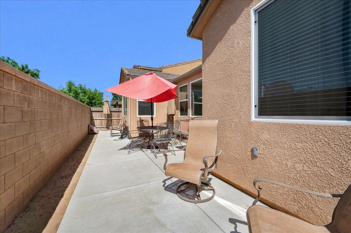 3012 Swift Lane Clovis, CA 93619 - Photo 27 of 40 a view of a patio with chairs and table under an umbrella