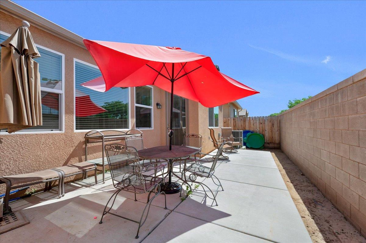 3012 Swift Lane Clovis, CA 93619 - Photo 28 of 40 a patio with tables and chairs under an umbrella