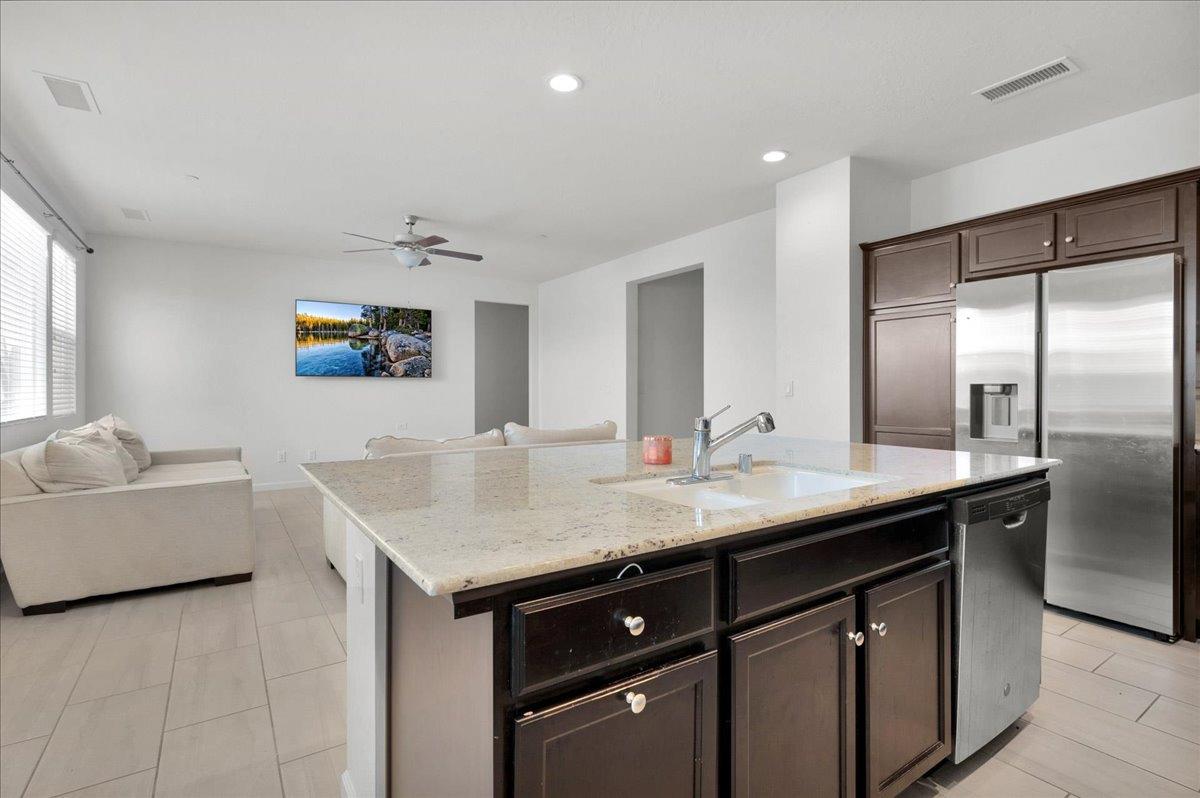 3012 Swift Lane Clovis, CA 93619 - Photo 8 of 40 a kitchen with a sink and a refrigerator