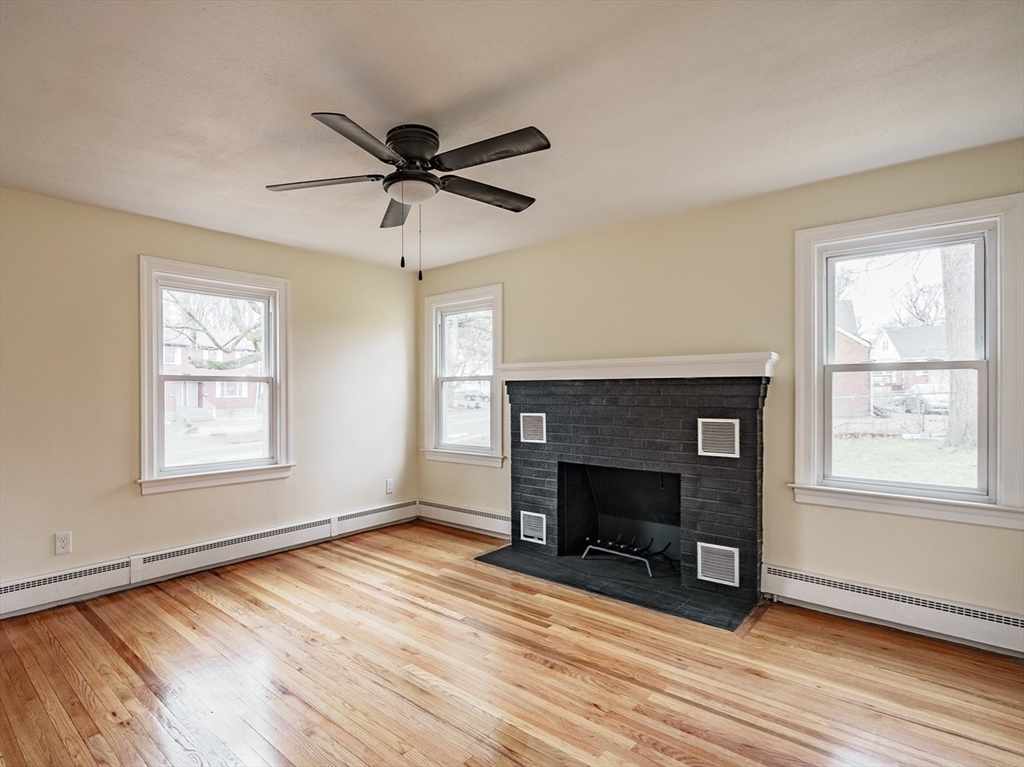 1174 Liberty Street Springfield, MA 01104 - Photo 11 of 34 a view of an empty room with wooden floor and a window
