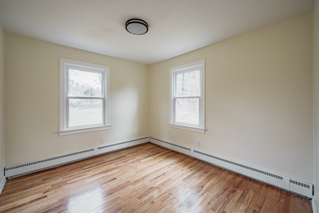 1174 Liberty Street Springfield, MA 01104 - Photo 12 of 34 an empty room with wooden floor and windows