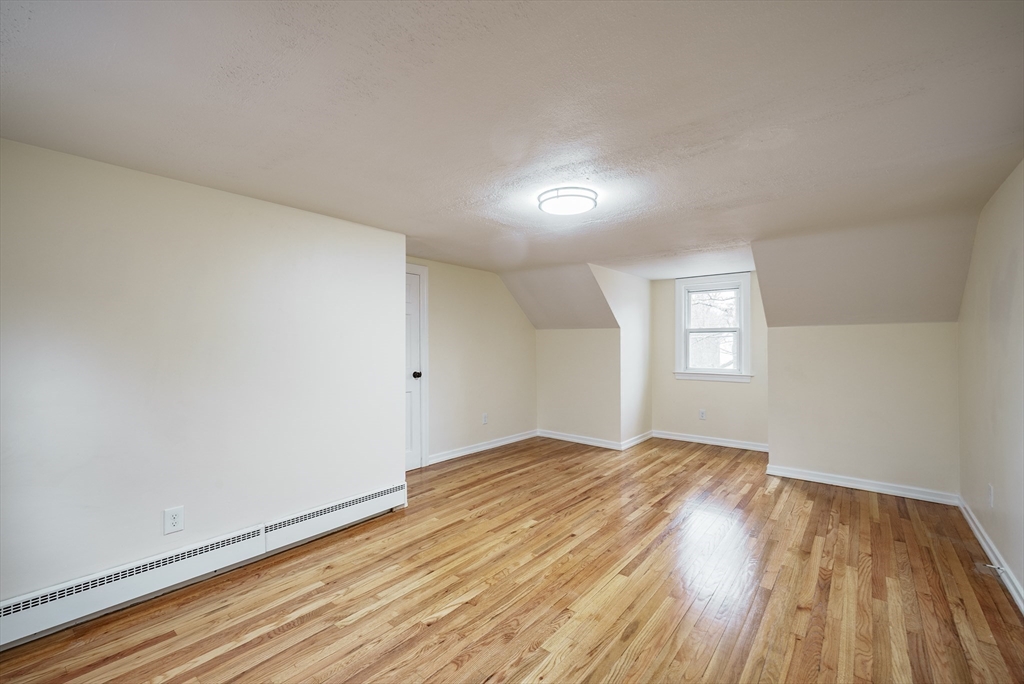 1174 Liberty Street Springfield, MA 01104 - Photo 16 of 34 an empty room with wooden floor and windows