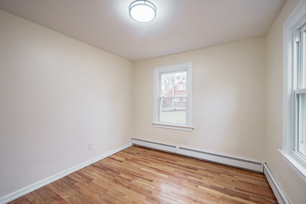 1174 Liberty Street Springfield, MA 01104 - Photo 20 of 34 an empty room with wooden floor and windows