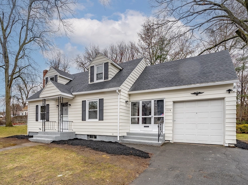 1174 Liberty Street Springfield, MA 01104 - Photo 2 of 34 a front view of a house with a garage
