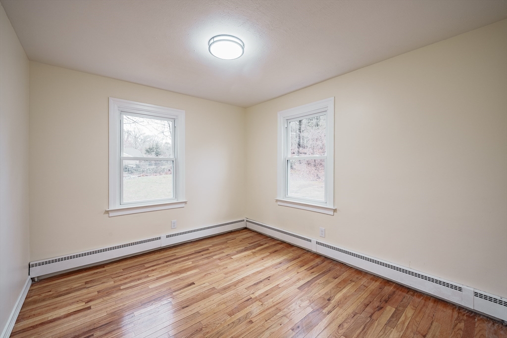 1174 Liberty Street Springfield, MA 01104 - Photo 23 of 34 an empty room with wooden floor and windows