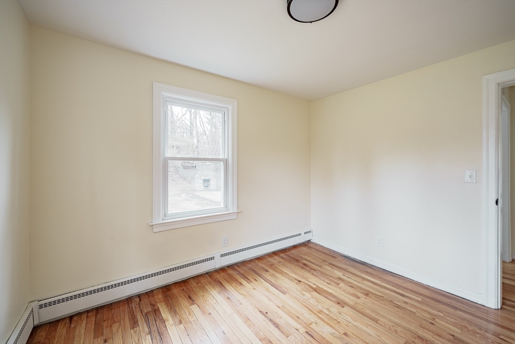 1174 Liberty Street Springfield, MA 01104 - Photo 24 of 34 a view of an empty room with wooden floor and window