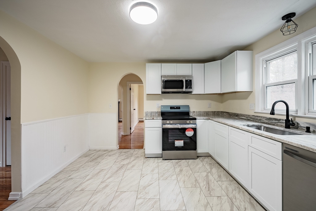 1174 Liberty Street Springfield, MA 01104 - Photo 27 of 34 a kitchen with stainless steel appliances a sink cabinets and a window