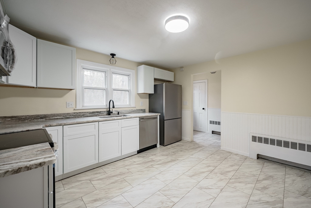 1174 Liberty Street Springfield, MA 01104 - Photo 3 of 34 a kitchen with a cabinets and a stove top oven